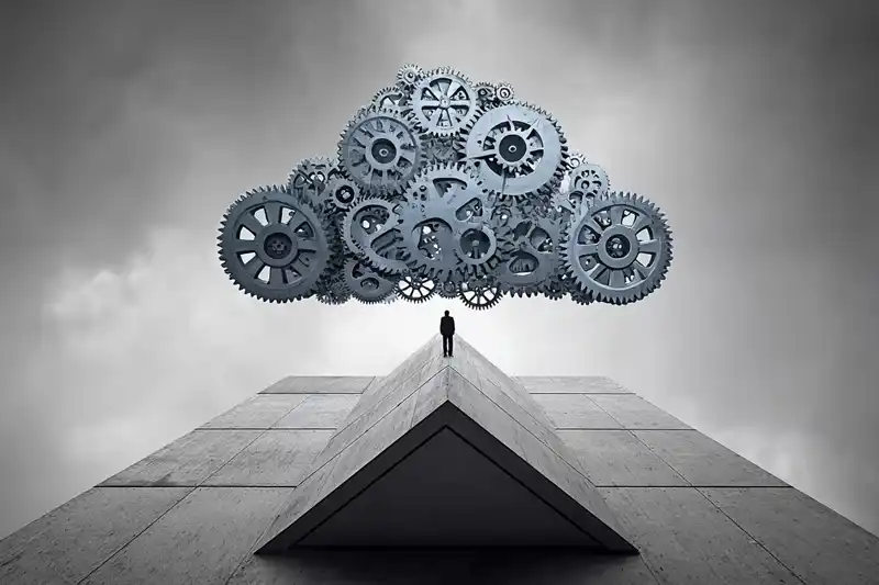 A futuristic image of a businessman standing under a floating group of cogs